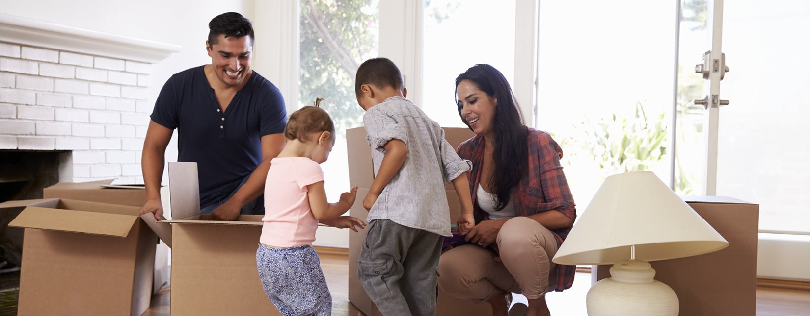 young family playing with empty boxes